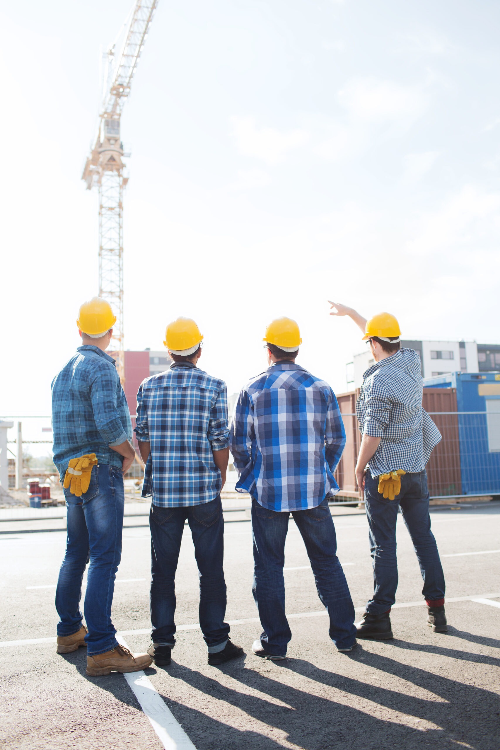 Courses Business Building Teamwork People Concept Group Builders Hardhats Outdoors From Back Scaled